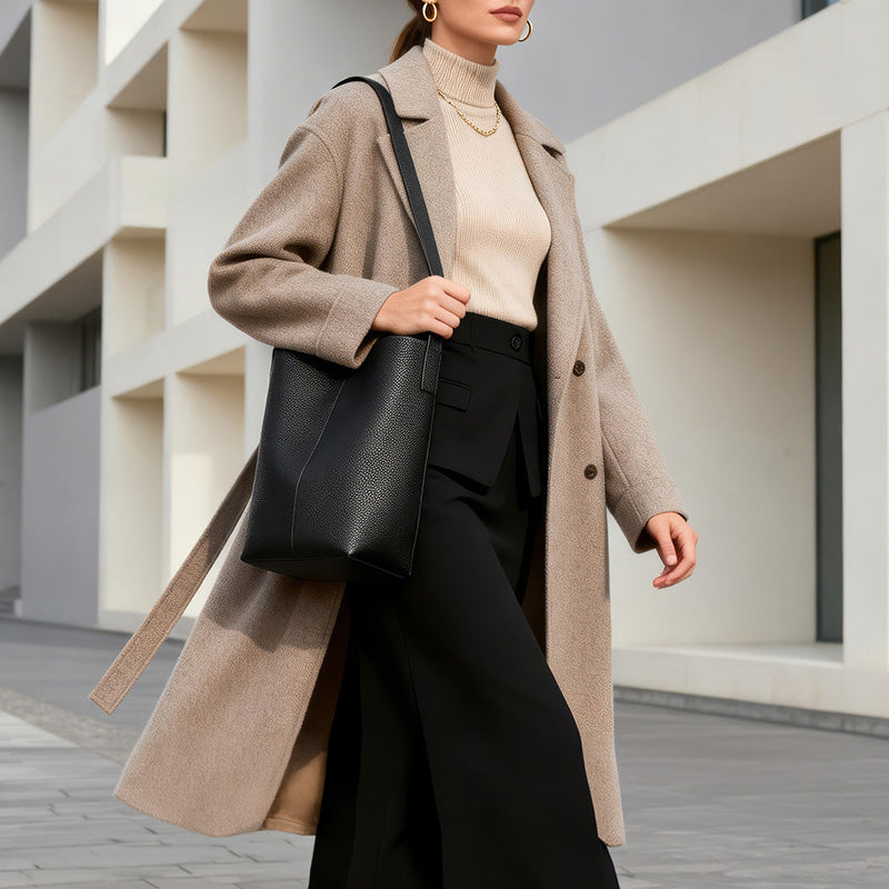 Black full grain leather bucket tote bag with slouchy silhouette and shoulder carry