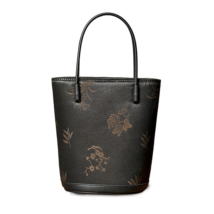 Black Xiangyunsha mulberry silk and leather bucket bag with adjustable crossbody strap, handcrafted in China.