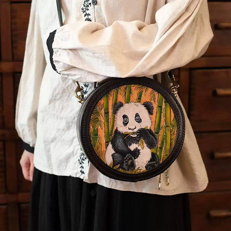A black leather canteen crossbody bag with hand-painted panda and bamboo art.