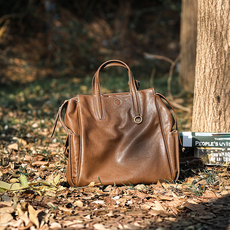 Brown vegetable tanned leather tote backpack with top handles, convertible for work and travel