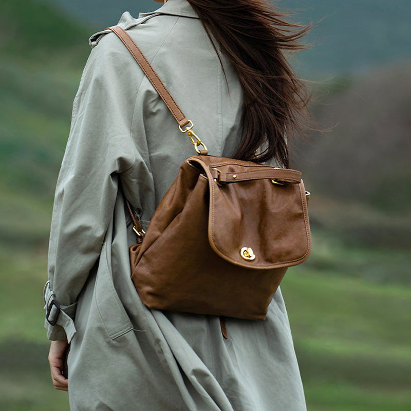 Brown vegetable tanned leather backpack with dual compartments and gold hardware