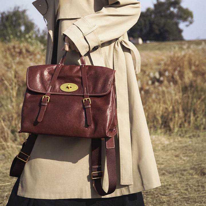 Brown vegetable tanned leather backpack with flap lock closure and gold-plated hardware