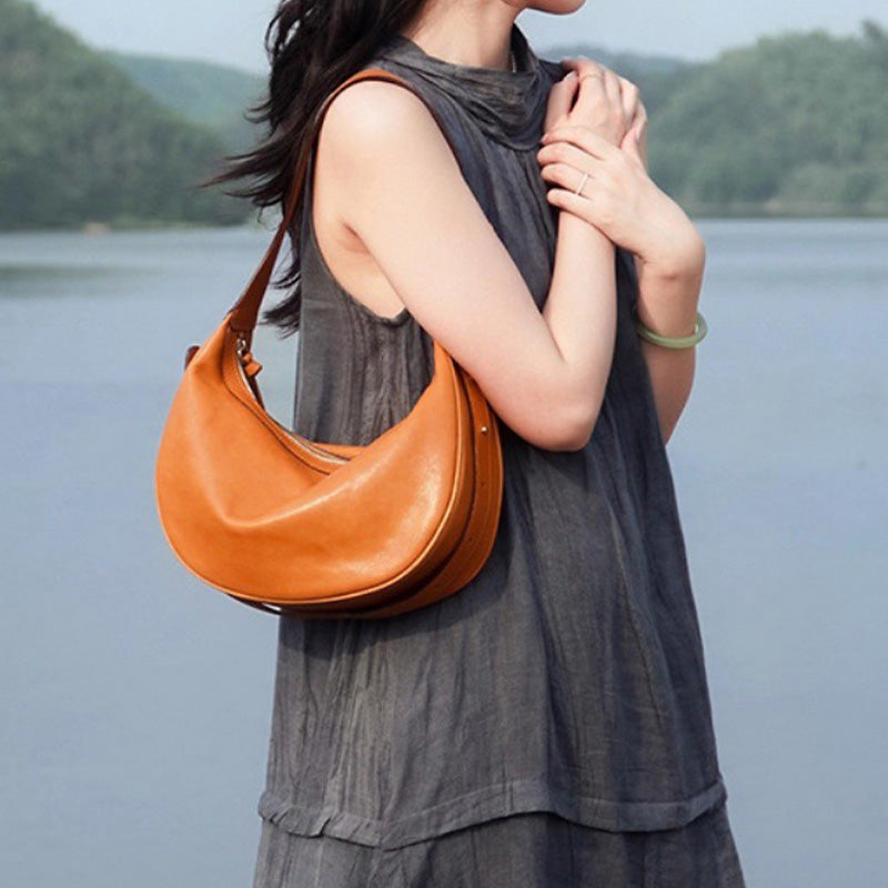 Camel vegetable tanned leather dumpling hobo bag with soft slouchy silhouette and adjustable strap