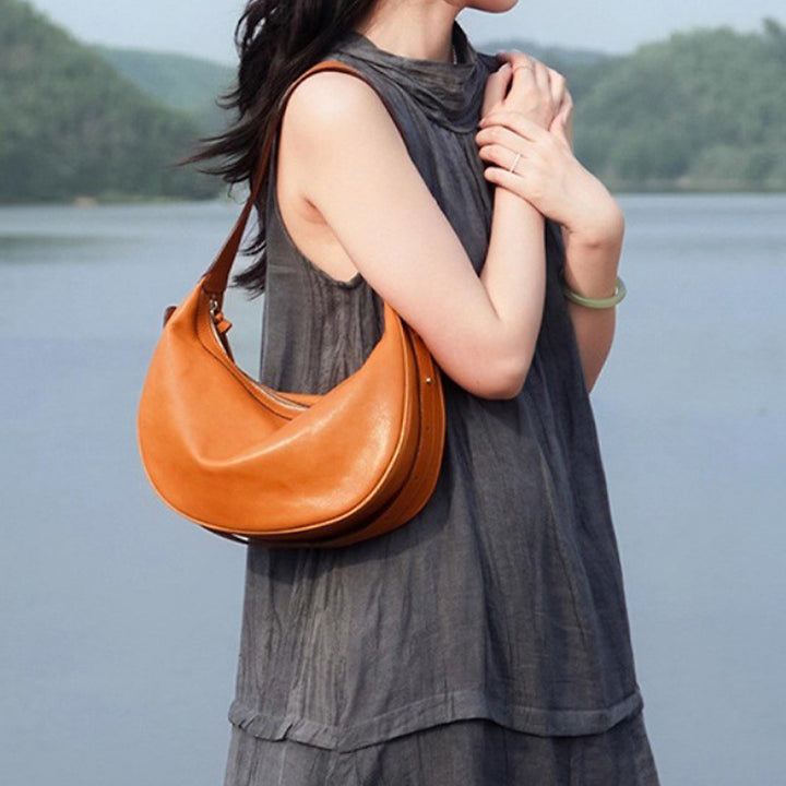 Camel vegetable tanned leather dumpling hobo bag with soft slouchy silhouette and adjustable strap
