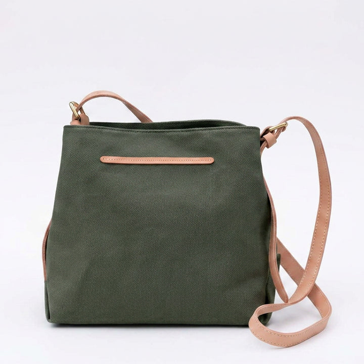 A small green canvas crossbody bag with leather strap.