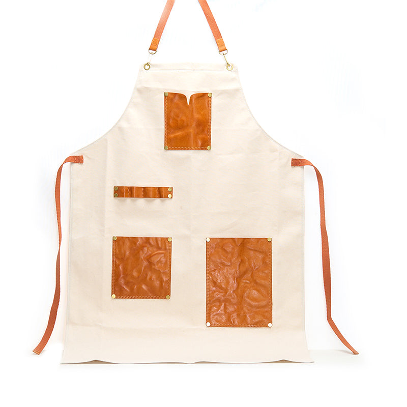 White canvas and leather apron with vegetable tanned leather pockets and brass rivets