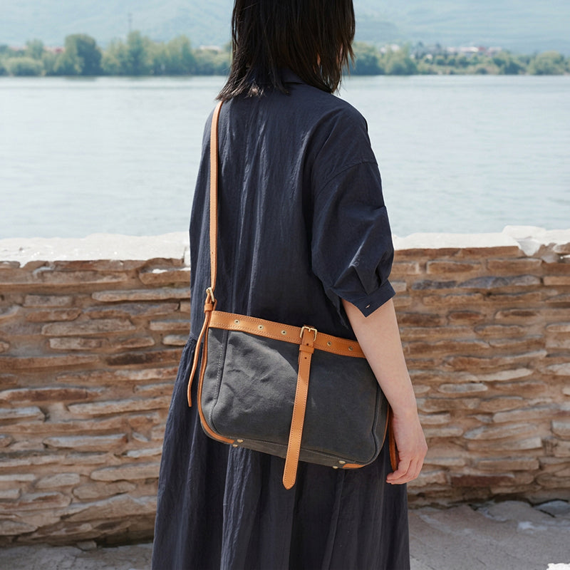Women wearing canvas leather messenger bag with buckle strap crossbody in dark gray