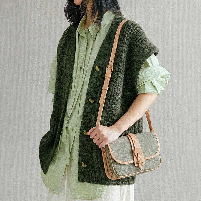 Woman wearing a canvas crossbody saddle bag with vegetable-tanned leather trim in khaki