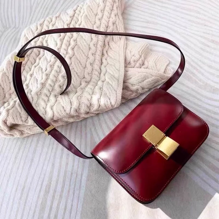 Red calfskin classic box bag with gold push-lock clasp and adjustable crossbody strap