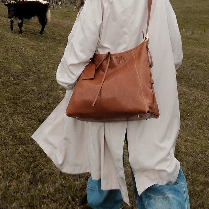 Coffee vegetable tanned leather hobo bag with slouchy silhouette and adjustable shoulder strap