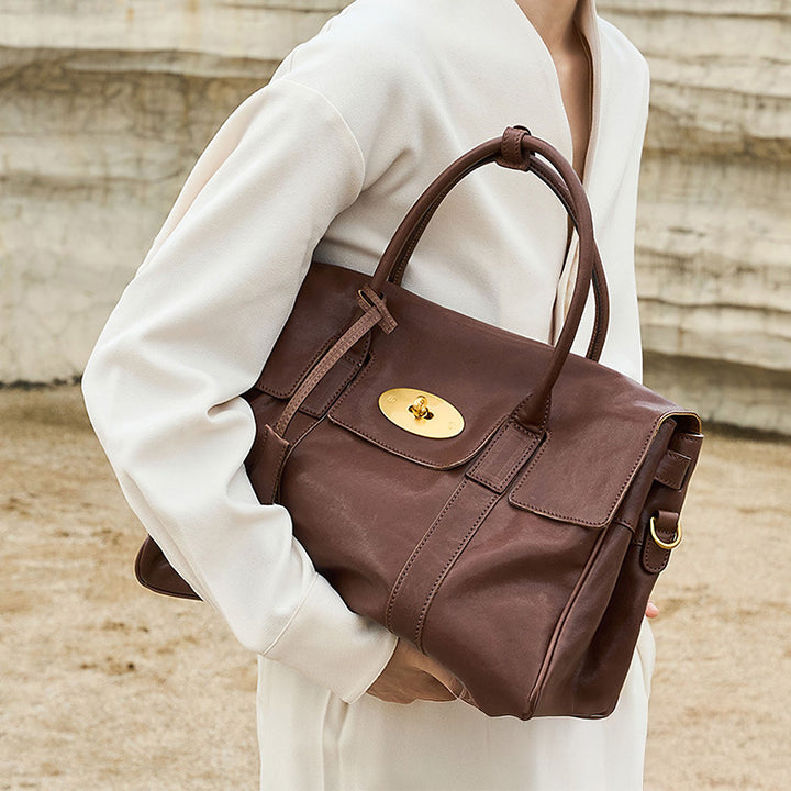 Coffee vegetable tanned leather satchel bag with gold turn-lock closure and detachable strap