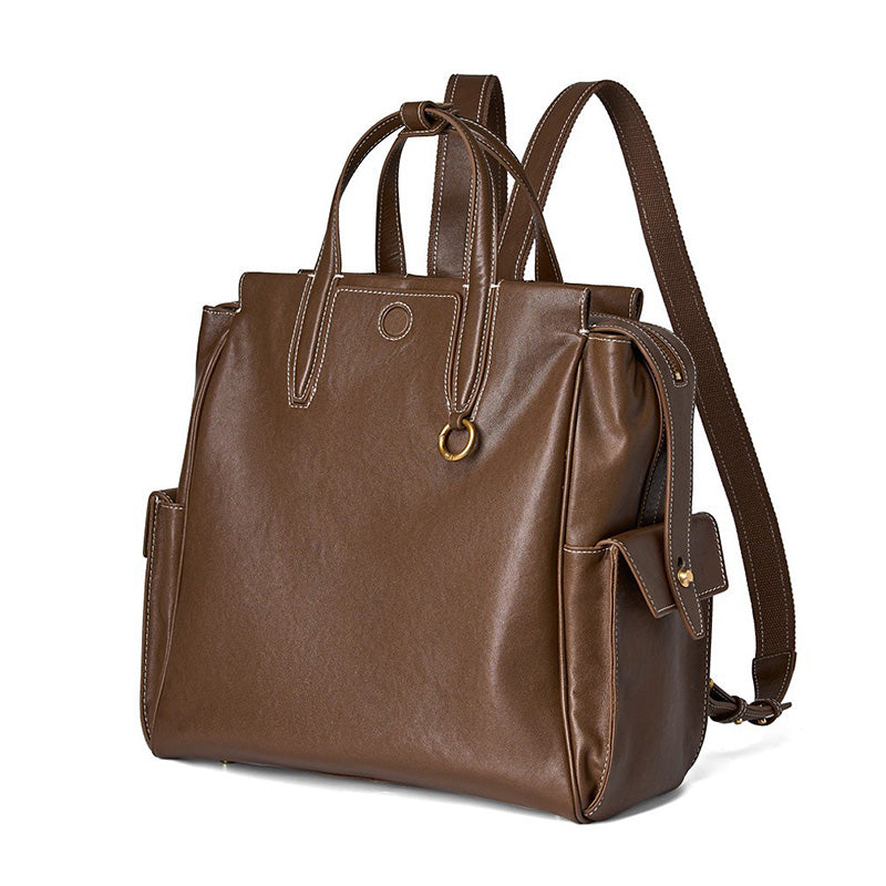 Convertible full grain leather tote backpack in brown — fits laptop, ideal for work and travel.