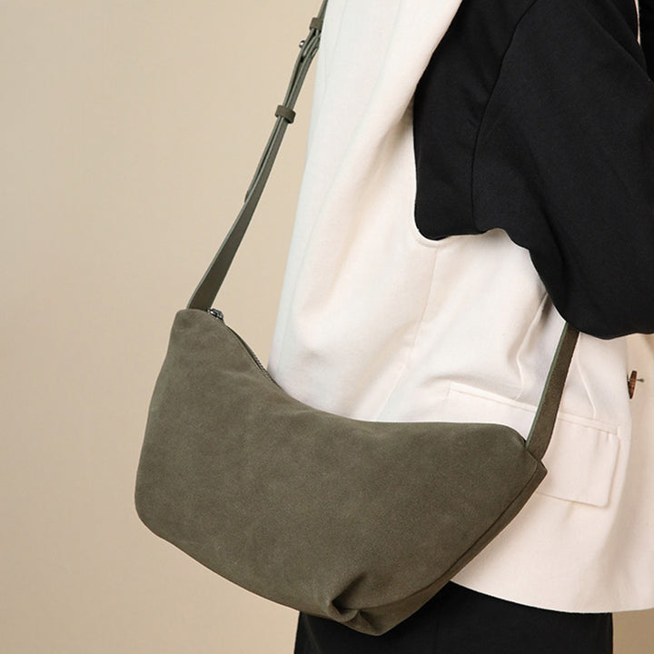 Dark green nubuck leather dumpling bag with adjustable crossbody strap