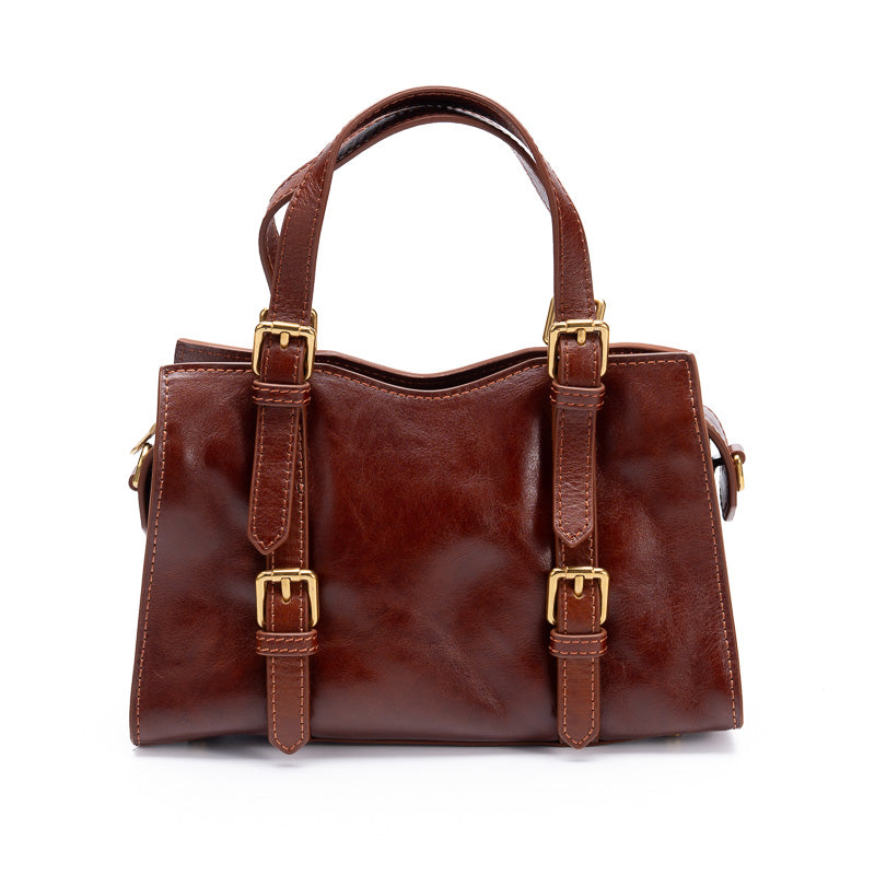 Brown full grain leather doctor bag with double buckle straps and twin top handles, front view
