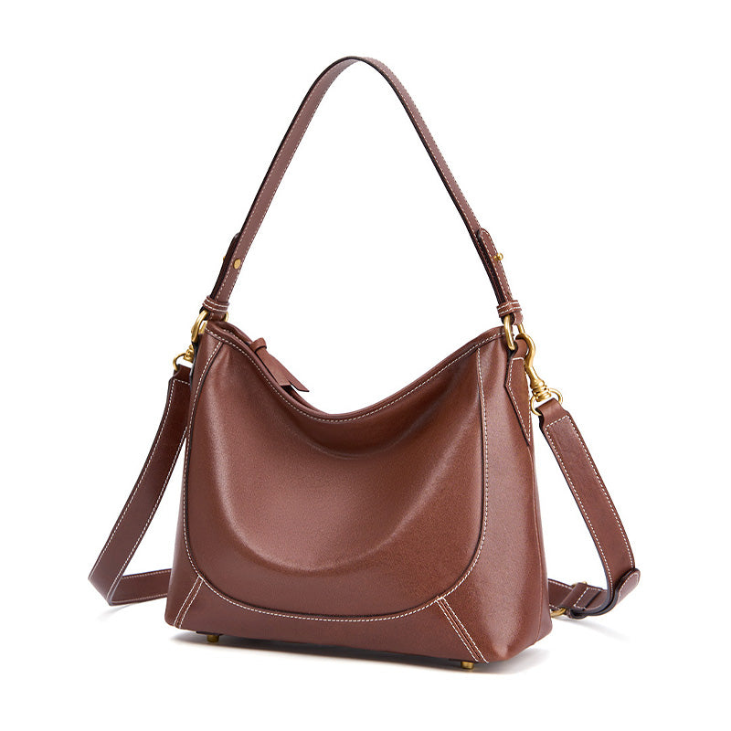 Vegetable tanned cowhide leather hobo tote bag in brown with dual adjustable straps and metal base feet