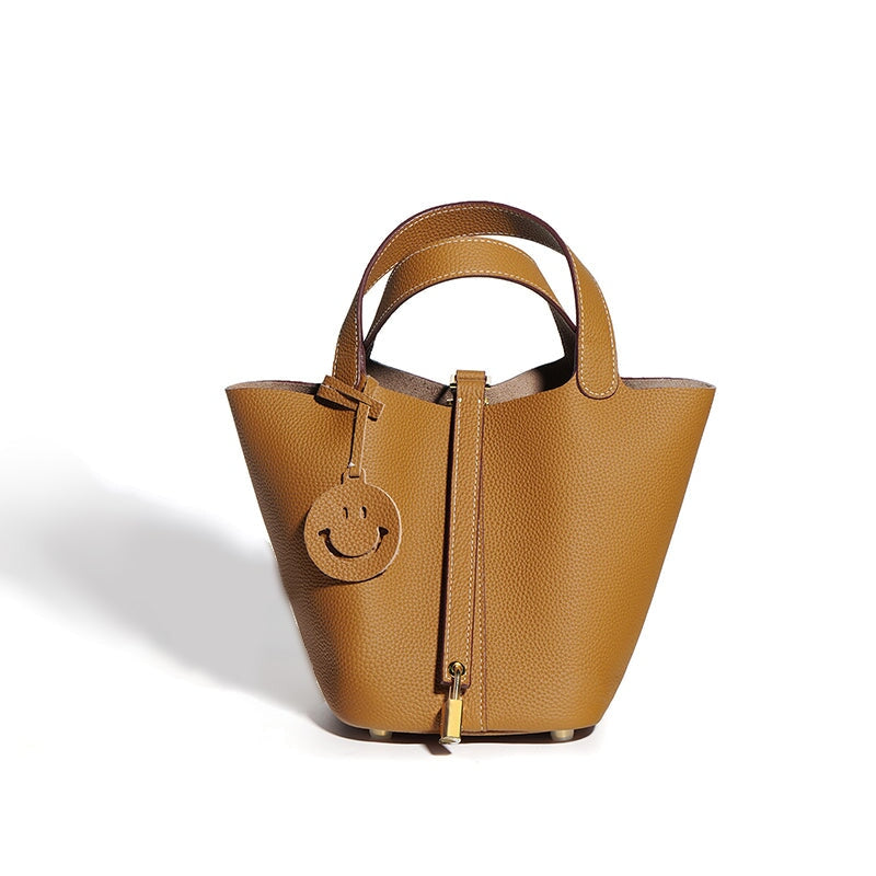 Small genuine leather bucket bag in brown with gold lock and smiley charm