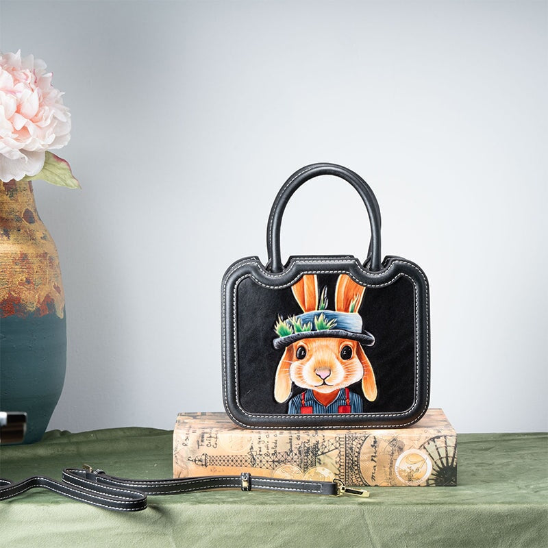 Hand painted gentleman rabbit on a hand tooled leather top handle bag in black