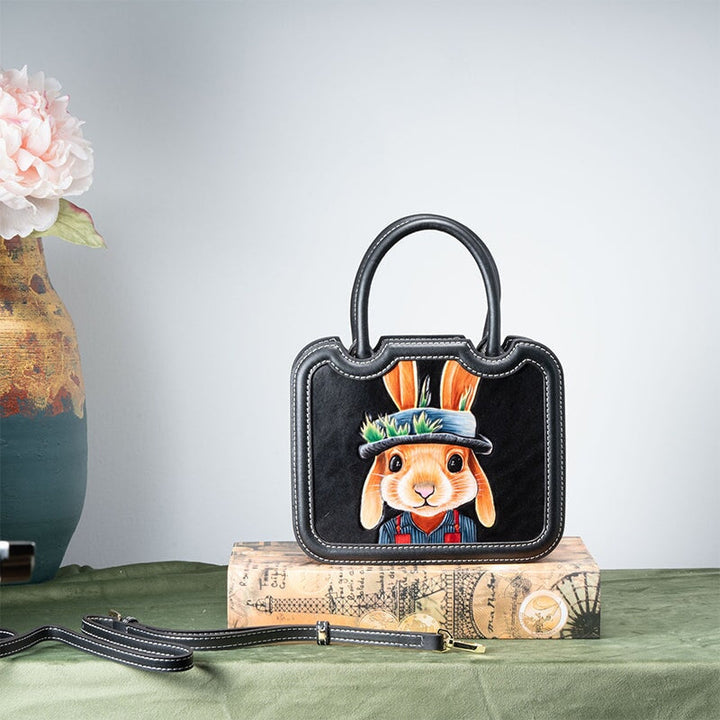 Hand painted gentleman rabbit on a hand tooled leather top handle bag in black