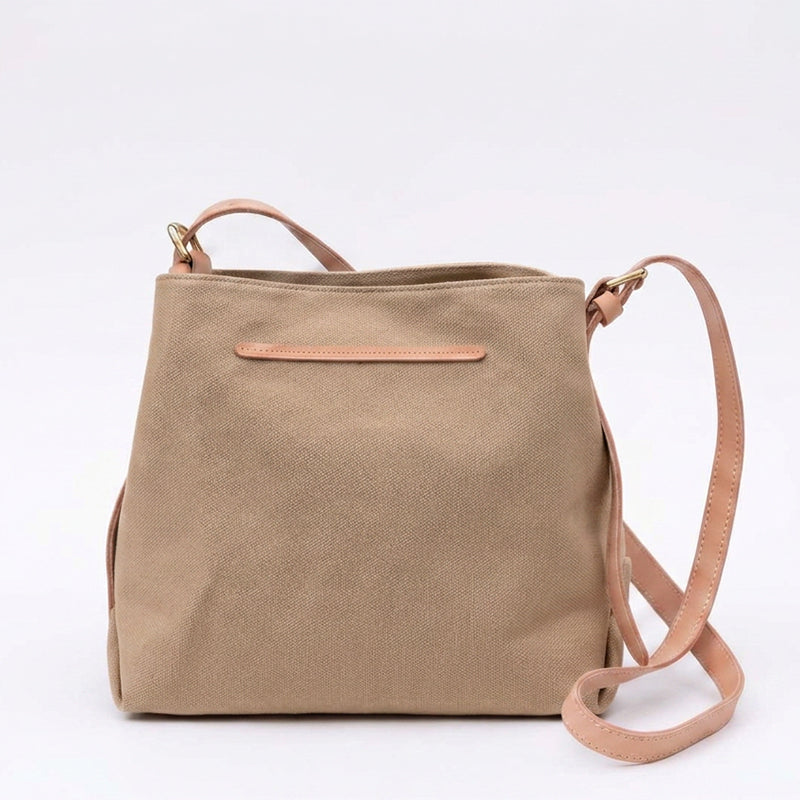 Khaki canvas crossbody bag with adjustable leather strap.