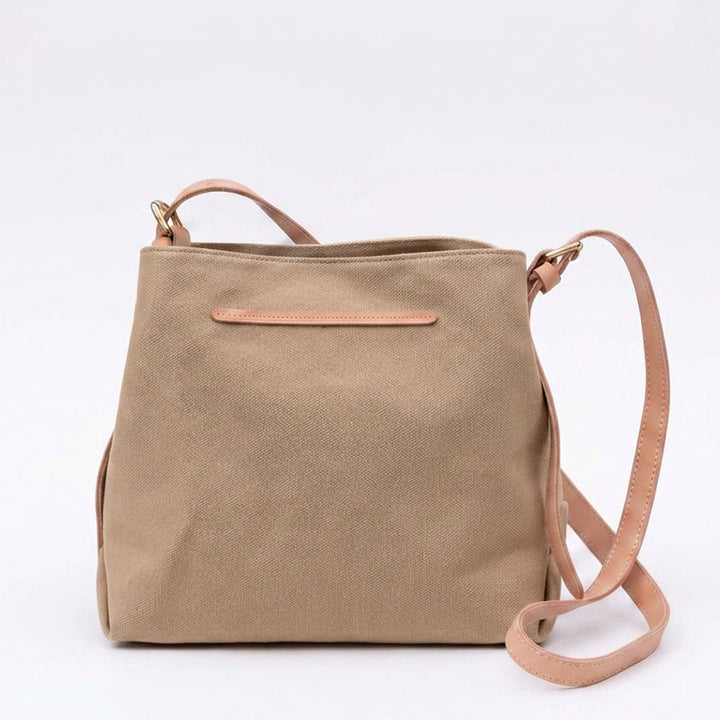 Khaki canvas crossbody bag with adjustable leather strap.