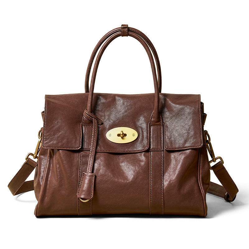 Large leather satchel in coffee brown — top grain vegetable-tanned cowhide with gold turn-lock closure.