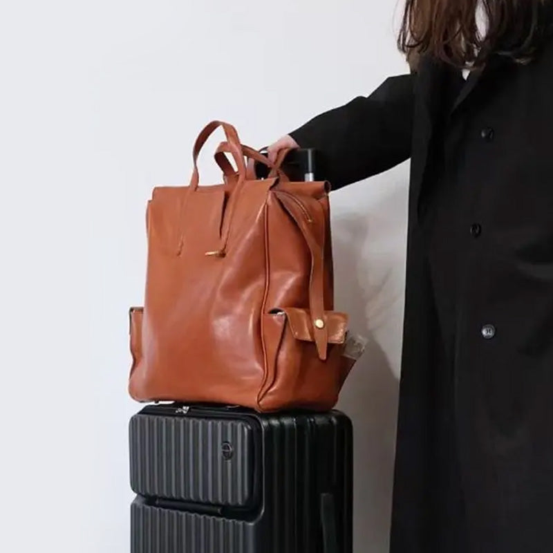 Large vegetable tanned leather backpack tote with top handles and gold-tone hardware, women's work bag