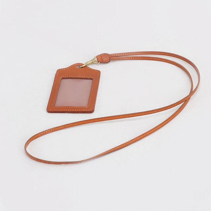 Yellow vegetable tanned leather badge holder with gold swivel clip and lanyard