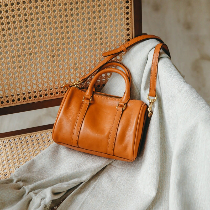 Women's vintage leather Boston bag in brown with gold zipper and top handles