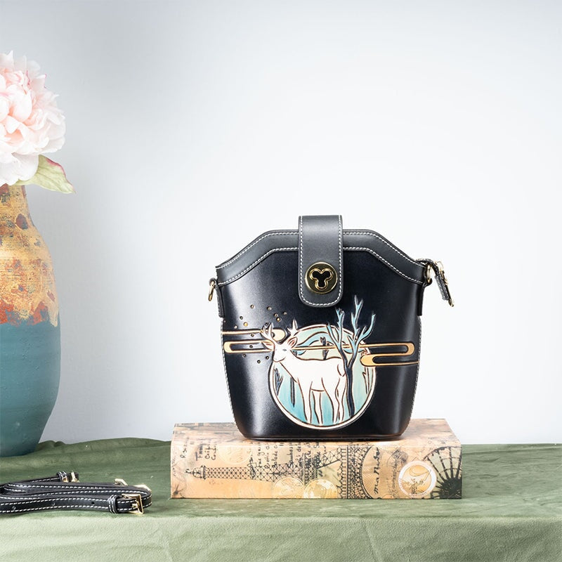 Hand tooled leather bucket bag with carved deer design, black crossbody style