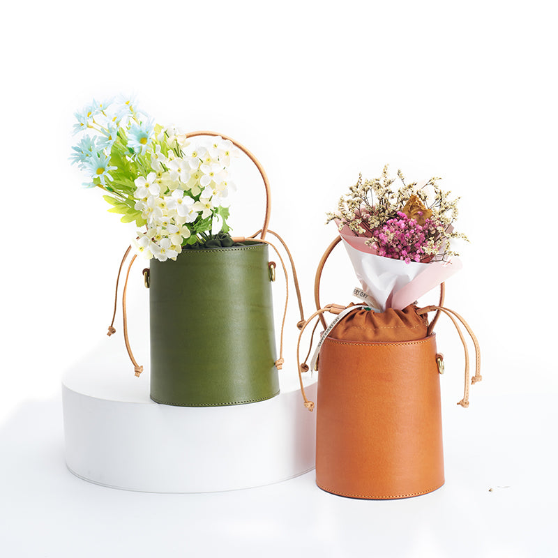 Vegetable tanned leather bucket bag with drawstring and round top handle