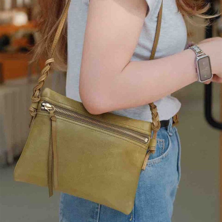 Handcrafted vegetable tanned leather crossbody bag in avocado green with adjustable strap