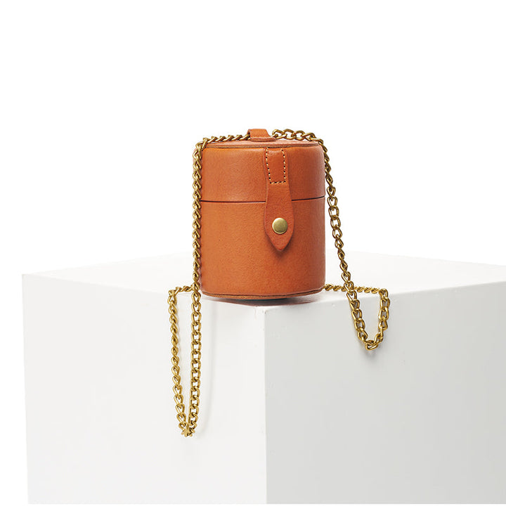 Yellow leather mini cylinder crossbody bag with gold snap closure