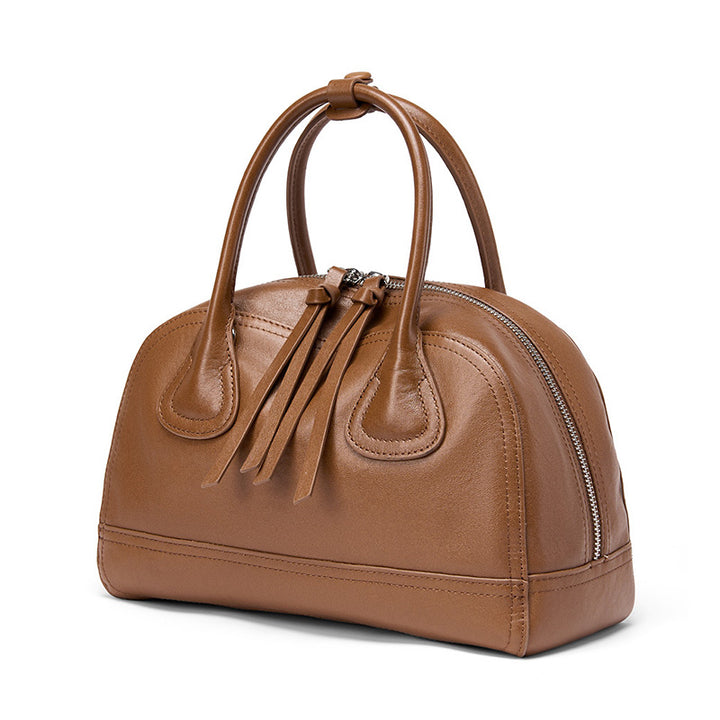 Brown vegetable tanned leather doctor bag with top handle and adjustable crossbody strap
