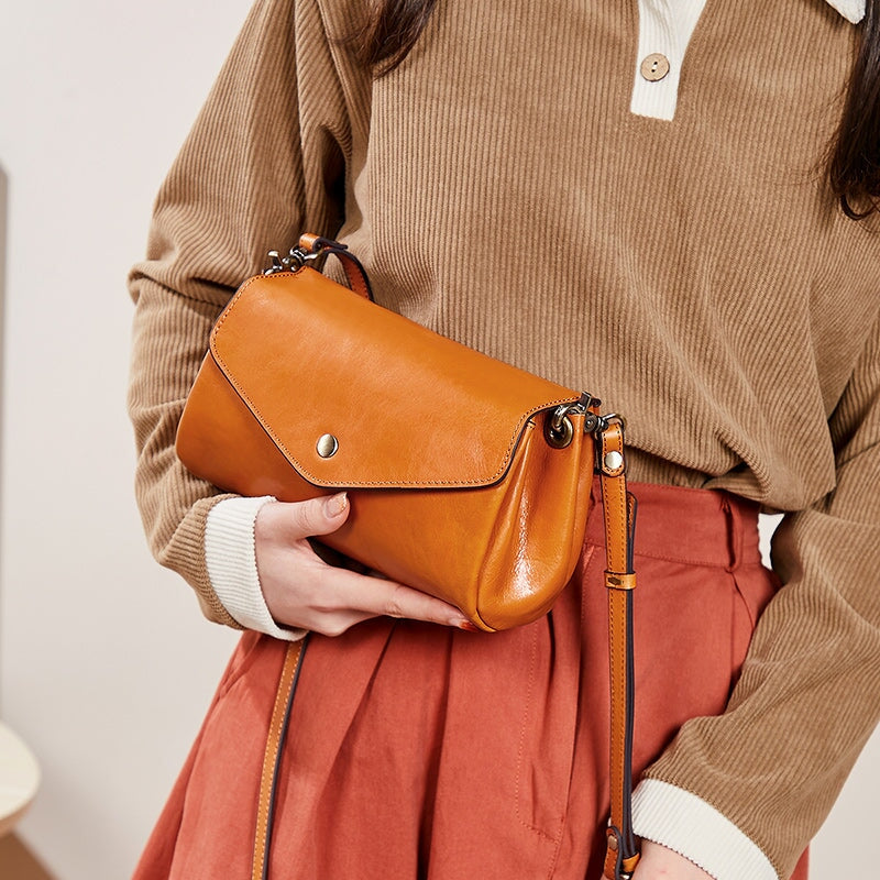 Women's vintage leather envelope crossbody bag in yellow with snap flap closure