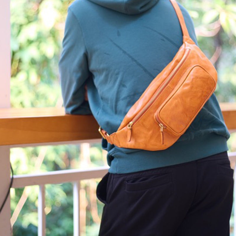 Man wearing a wax vegetable tanned leather fanny pack in sunset yellow at waist