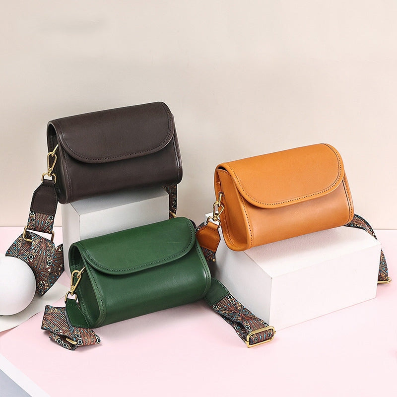 Small leather flap crossbody bags in brown, green and orange with wide boho strap