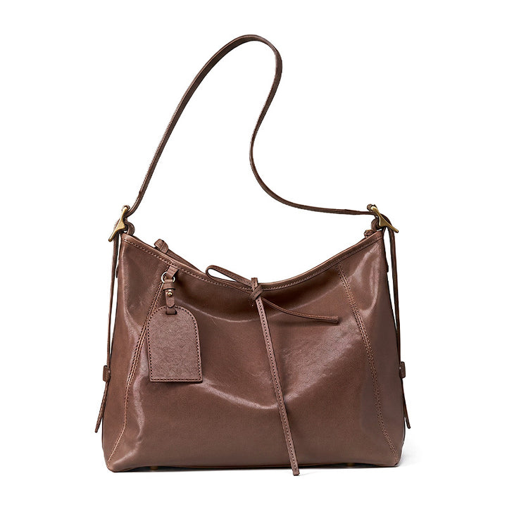 Slouchy leather hobo bag in coffee brown, crafted from top grain vegetable-tanned cowhide with platinum hardware.