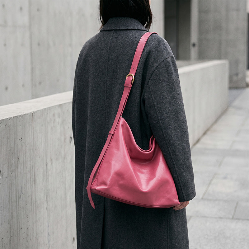 Red leather hobo bag worn crossbody, vegetable tanned slouchy shoulder bag