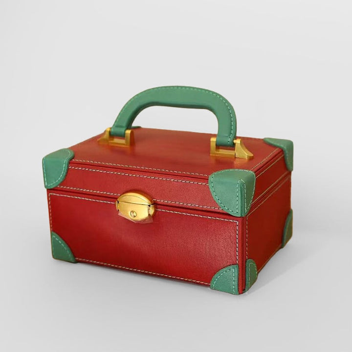 Handcrafted vegetable tanned leather jewelry box in red with vintage suitcase design, lock and mirror