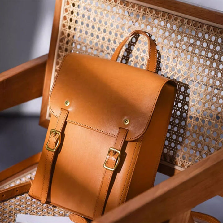 Vegetable tanned leather mini backpack with Cambridge satchel flap design in yellow.