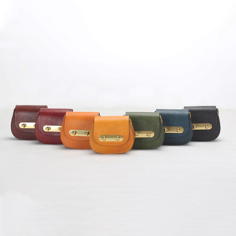 Vegetable tanned leather mini saddle bag with double gold twist-lock clasp and chain strap