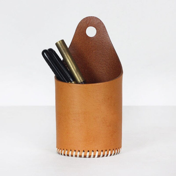 Handmade vegetable tanned leather pen holder in yellow holding pens on desk