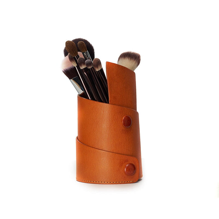 Vegetable tanned leather pen holder for desk in sunset yellow, filled with makeup brushes