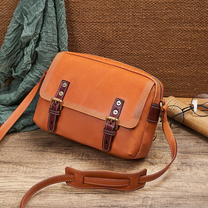 Vintage leather satchel crossbody bag for women in cognac tan with double buckle straps and brass hardware