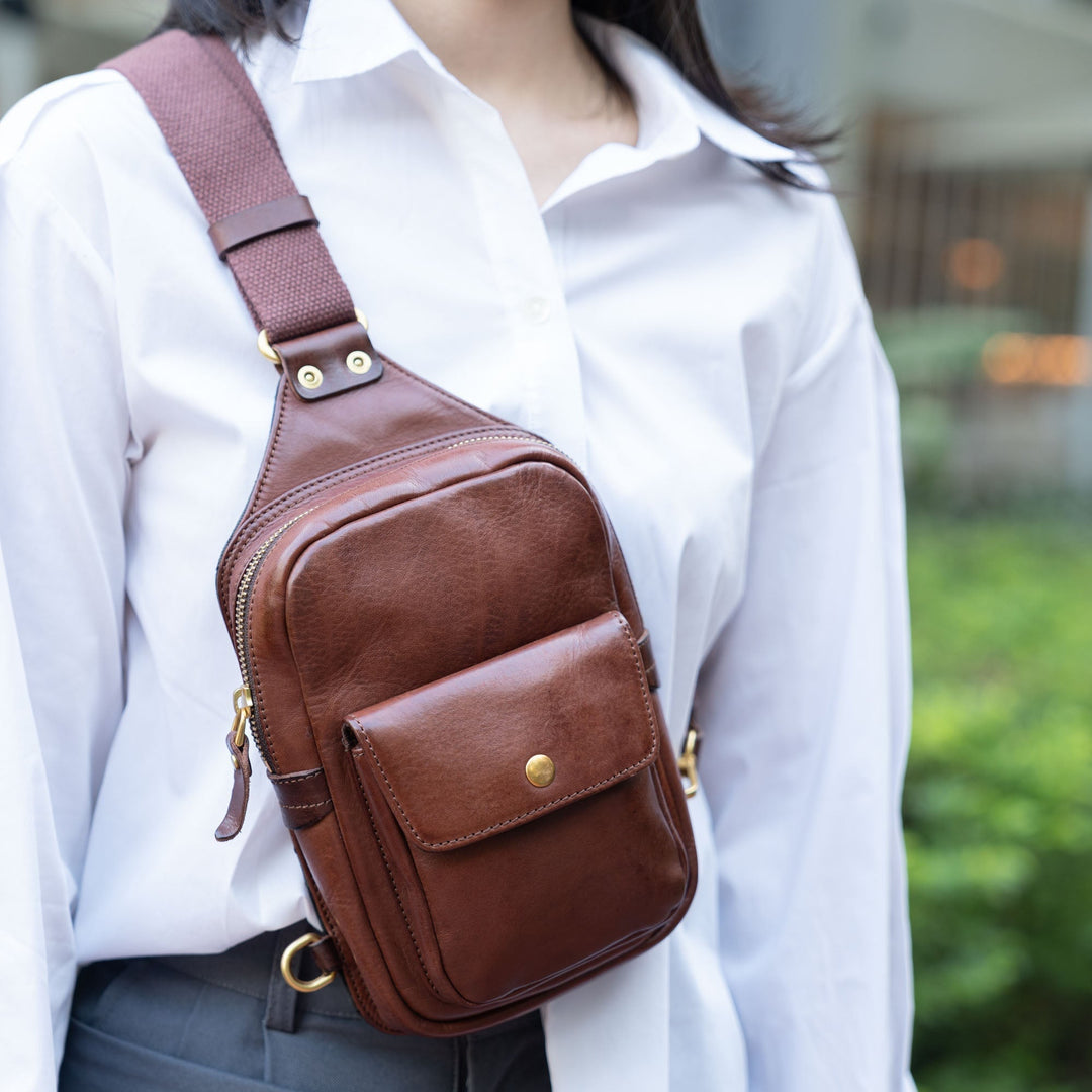 Vegetable tanned leather sling bag in brown with front snap pocket