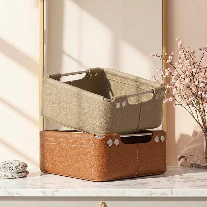 Stacked gray and brown leather storage baskets styled in a sunlit home setting