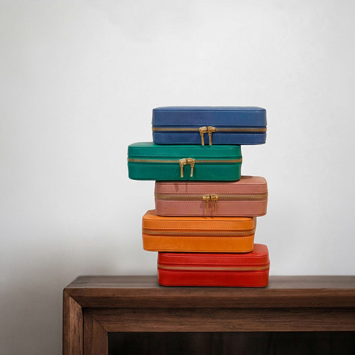 Vegetable tanned leather travel jewelry case with double zipper closure, open view showing mirror and velvet-lined compartments.