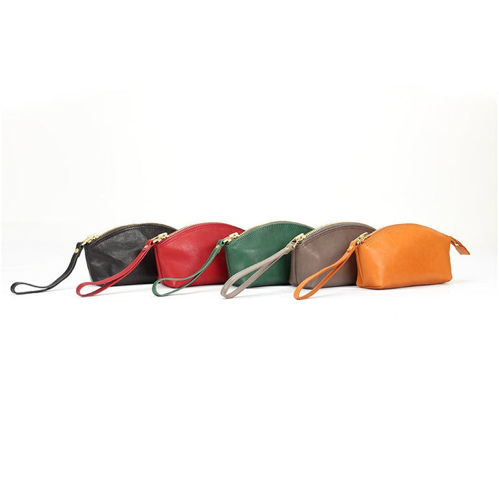 Vegetable tanned leather wristlet clutch bag with dome zip and gold hardware