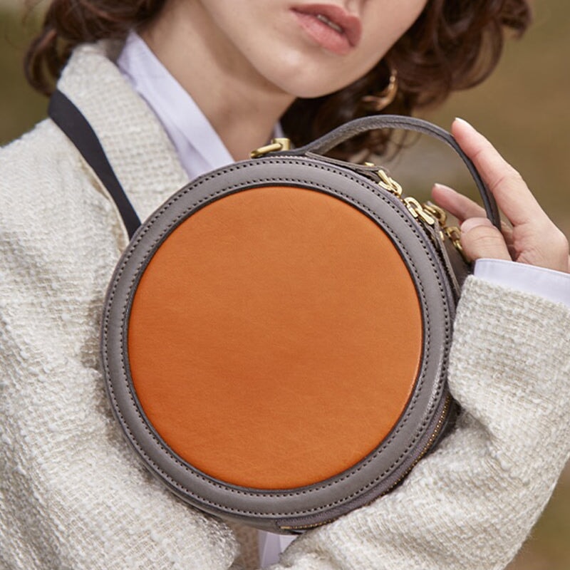 Mini round vegetable tanned leather circle bag in sunset yellow, crossbody style