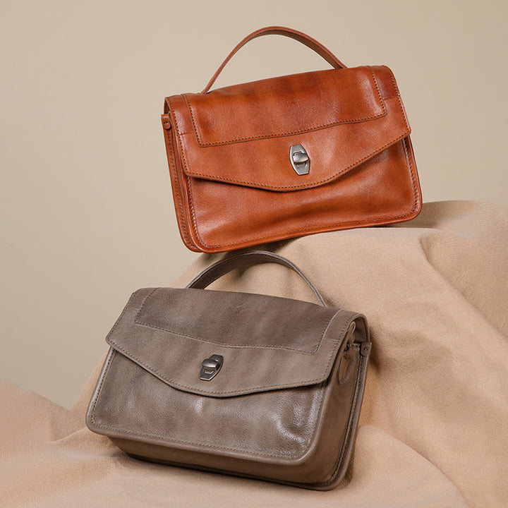 Red and gray calfskin leather satchel bag with twist-lock closure and detachable crossbody strap